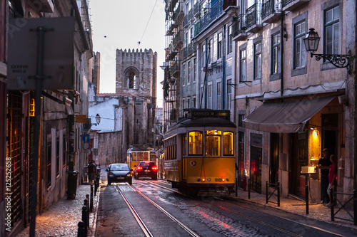 Tram car crossing street at evening in Lisbon, Portugal