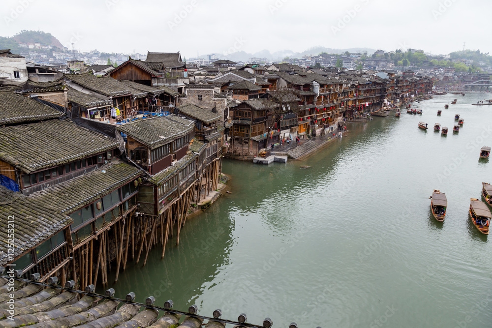 Old Houses on the river in Fenghuang Ancient town, Hunan province, China. This ancient town was added to the UNESCO World Heritage Tentative List in the Cultural category.