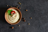 Creamy sauce with garlic, eggs and pepper on a black background.