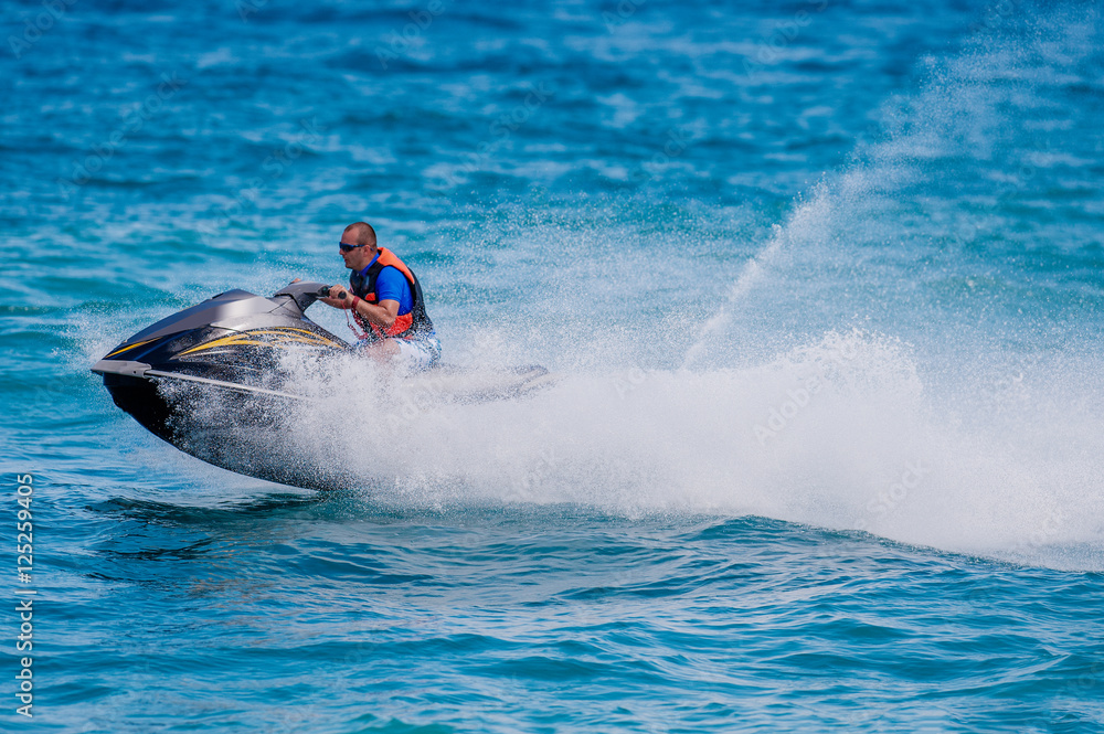Young Man on Jet Ski, Tropical Ocean, Vacation Concept