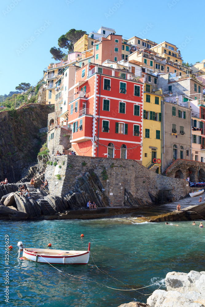 Port of Cinque Terre village Riomaggiore with colorful houses, Italy