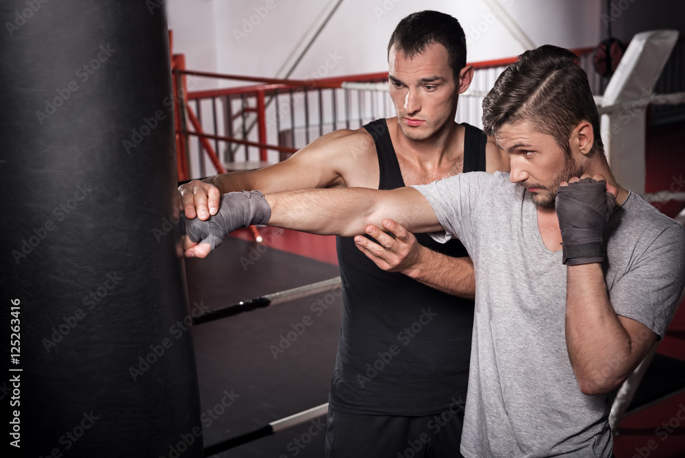 Trainer teaches how to punch a bag