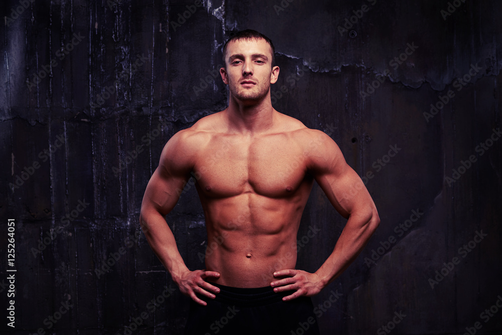 Fototapeta premium Portrait of male model showing his reliefed body