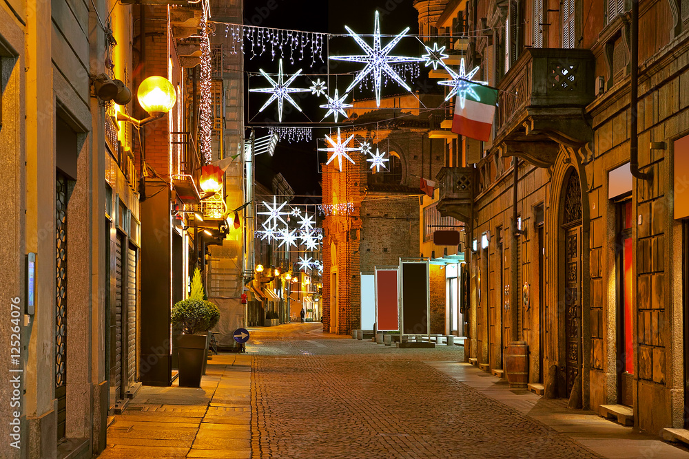 Central street at evening. Alba, Italy.