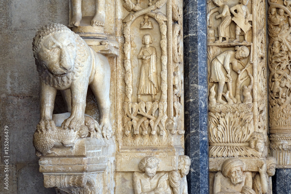 Carvings next to the western portal of Trogir cathedral , Croatia