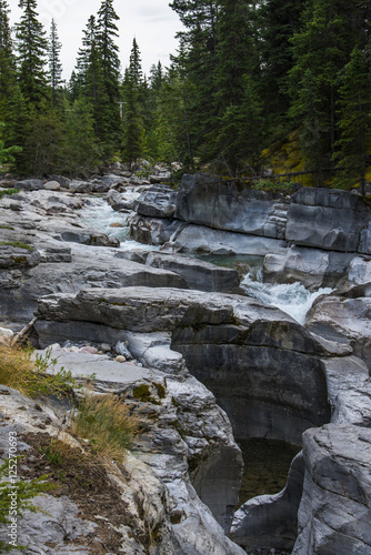 Carved rocks by stream in Banff national park © studiodr