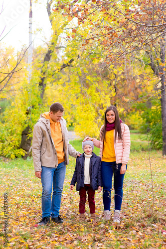 Family walks in the autumn park