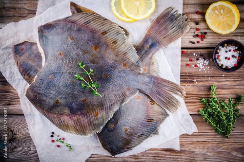 Fotografie, Tablou Raw flounder fish, flatfish on wooden table