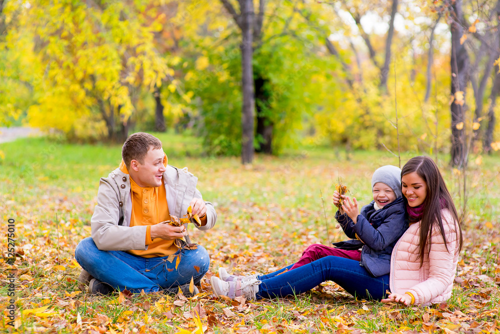 Fototapeta premium family playing with leaves autumn park