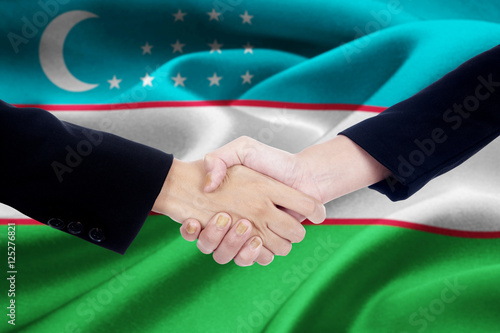 Two hands business team with Uzbekistan flag