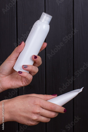 Close view of girl's hand with white tube
