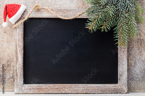 Christmas chalkboard and decoration over wooden background.