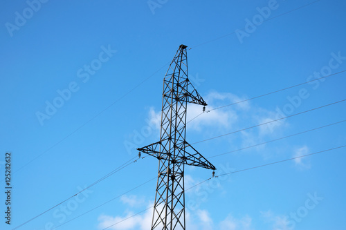 High voltage electric tower in the blue sky white cloud background