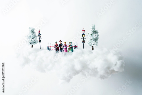 Christmas carolers floating on a cloud of cotton
