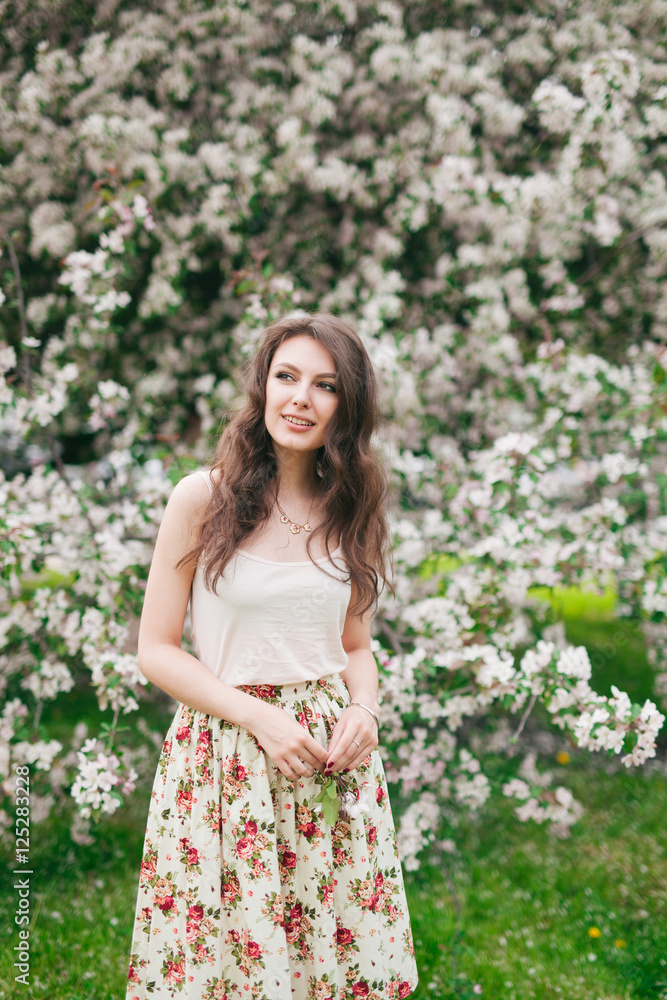 portrait of young lovely woman in spring flowers, 20s portrait of young lovely woman in spring flowers, 20s