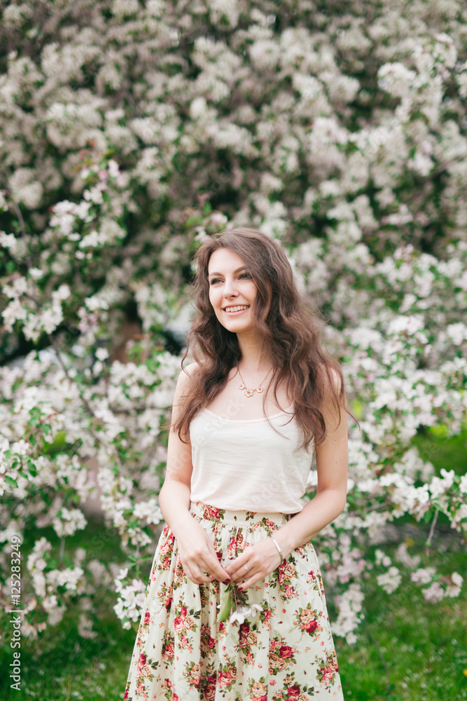 portrait of young lovely woman in spring flowers, 20s portrait of young lovely woman in spring flowers, 20s