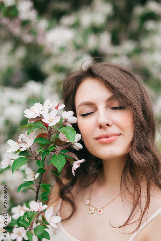 Beautiful portrait of woman in the garden with flower cherry Beautiful portrait of woman in the garden with flower cherry