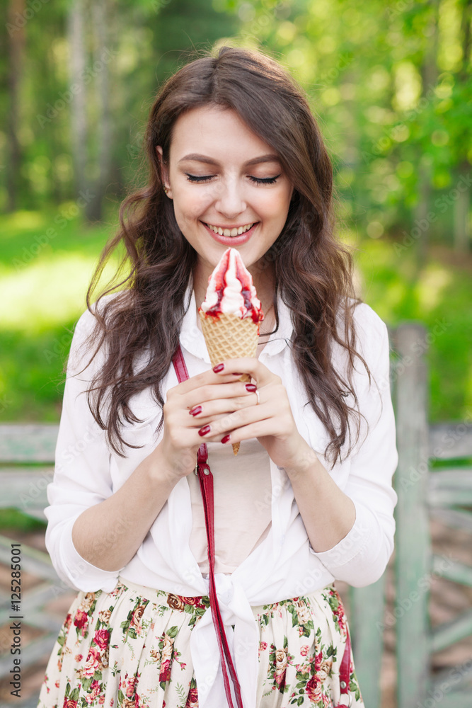 Outdoor closeup portrait of girl eating ice cream in summer Outdoor closeup portrait of girl eating ice cream in summer