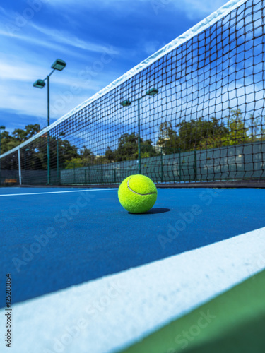 Tennis Ball on Blue Court