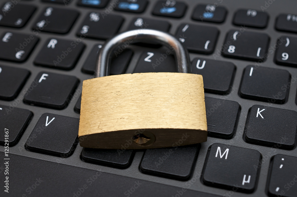Cyber safety concept - lock on computer keyboard 