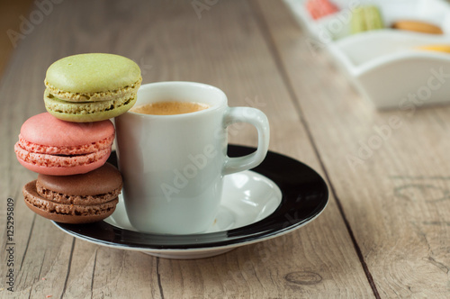 Colorful macaroons over turquoise wood backround