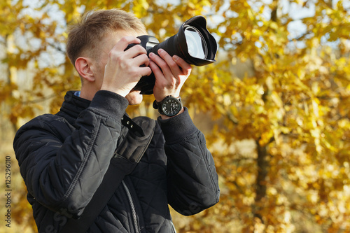 young photographer shoots nature landscape