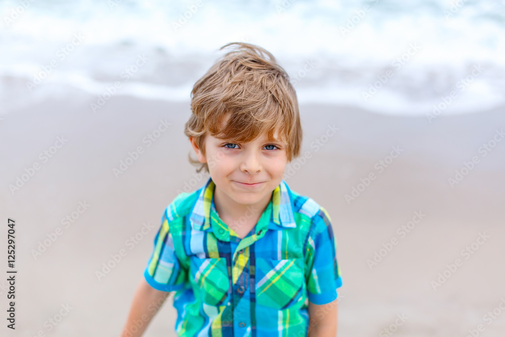 little kid boy on the beach of ocean little kid boy on the beach of ocean