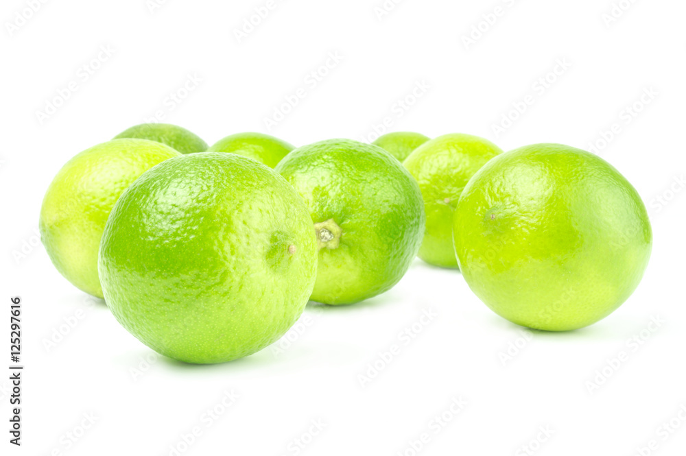 Scattered fresh limes isolated on white Scattered fresh limes isolated on white