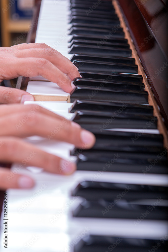 Man playing piano with both hands portrait view 3