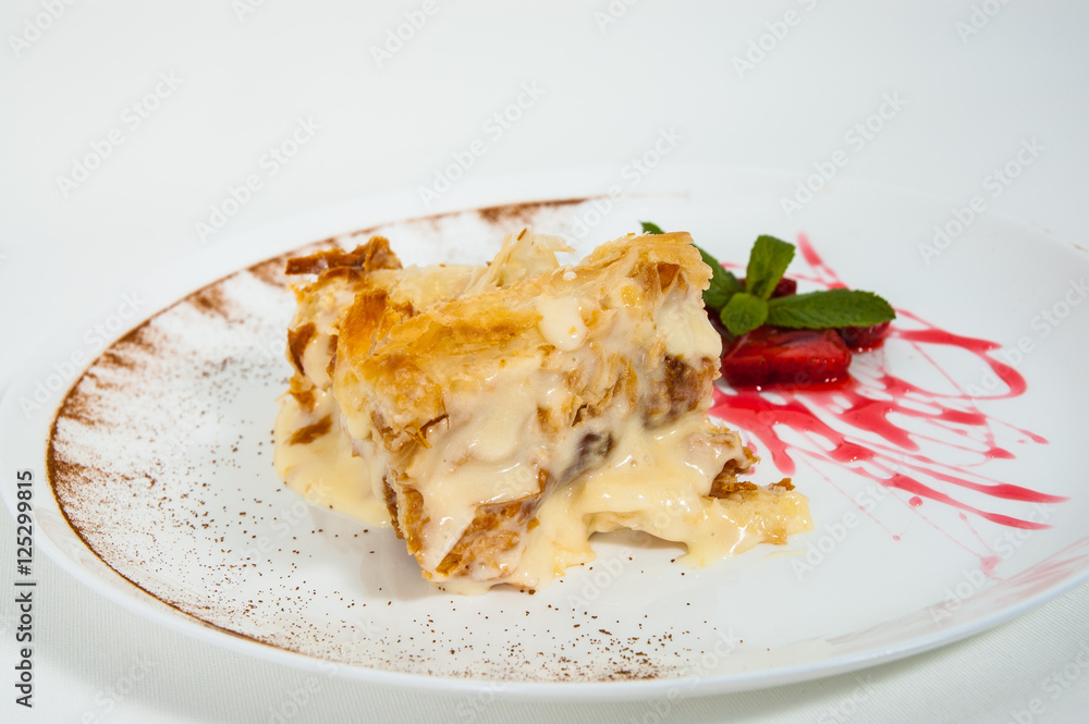 slice of decorated with strawberry napoleon cake, served on white plate