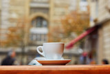 Cup with hot beverage in Parisian outdoor cafe