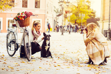 Two women tourists taking photos in the city