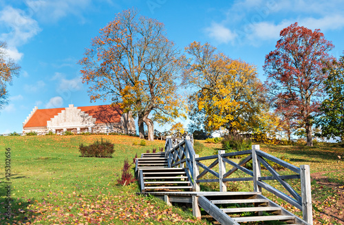 Wooden stairs leading to a countryside building, autumn in Europe