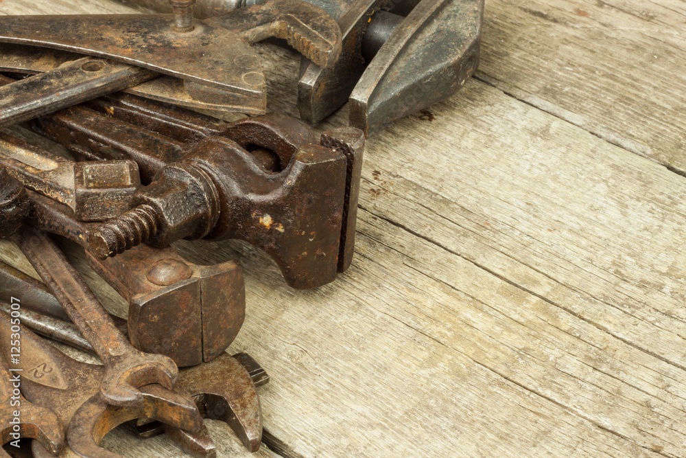 Dirty set of hand tools on a wooden background. Old rusty tools. Equipment for locksmith and metalworking shop. Sales tools for assembly workers. Old shop.
Dirty set of hand tools on a wooden background. Old rusty tools. Equipment for locksmith and metalworking shop. Sales tools for assembly workers. Old shop.