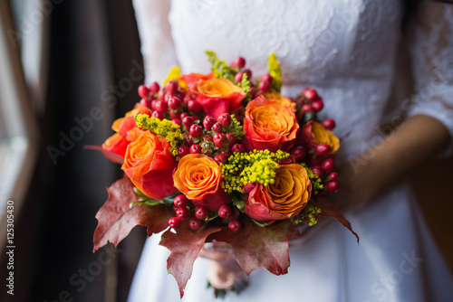 Fototapeta Naklejka Na Ścianę i Meble -  Bride holding wedding Colorful bouquet of autumn flowers