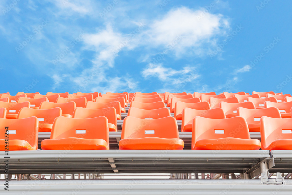 Naklejka premium Orange empty stadium seats in arena