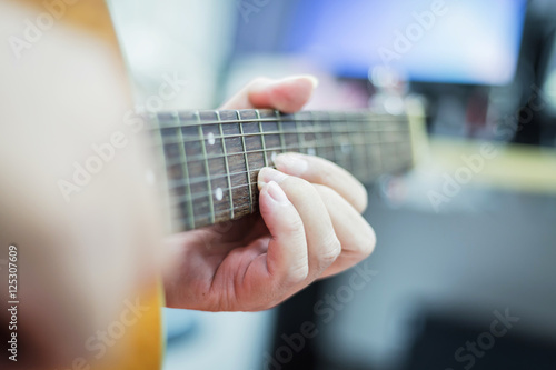 playing acoustic guitar close-up