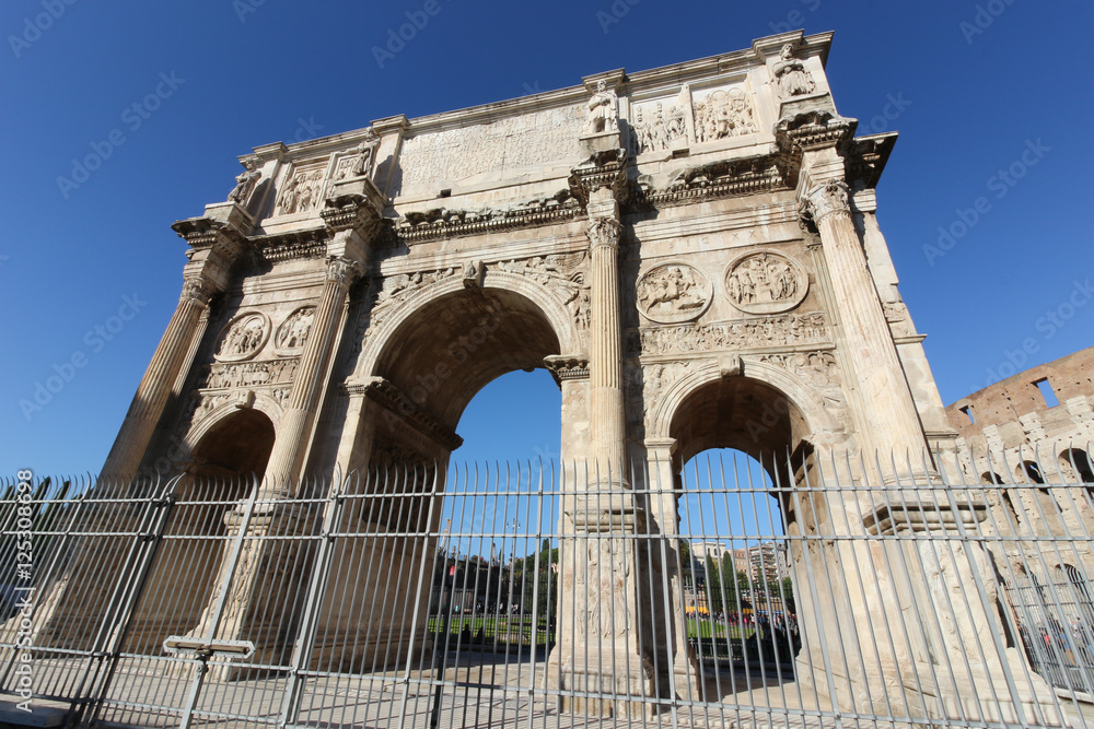 The Arch of Constantine (Arco Constantino), a ruin of the ancient Roman empire stands alongside the Colosseum in Rome, Italy.