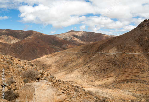 Beautiful volcanic mountains and the road on a mountain slope. Road from la Pared to Betancuria . Fuerteventura. Canary Islands