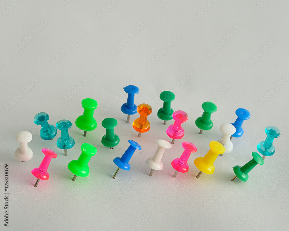 Colorful push pins displayed on a white background Colorful push pins displayed on a white background