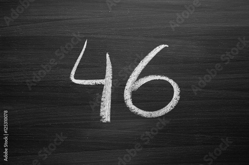 number forty six enumeration written with a chalk on the blackboard