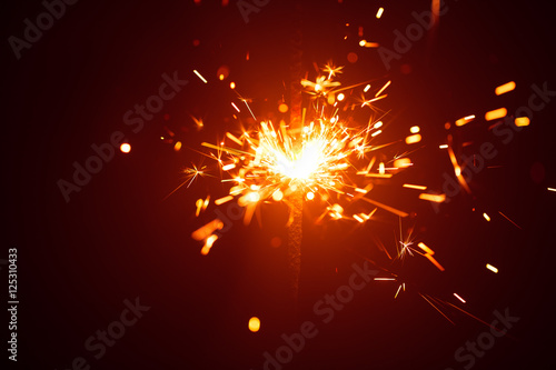 Christmas sparkler in haze with red light