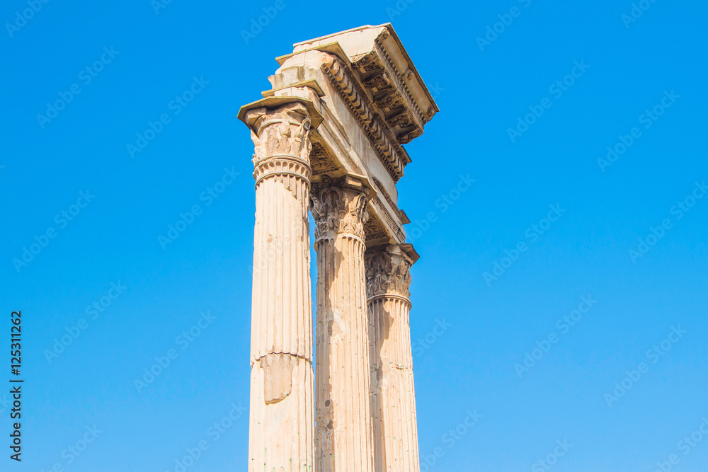      Ruins and columns of temple of Castor and Pollux in Roman Forum (Forum Romanum), blue sky in background, Rome, Italy 