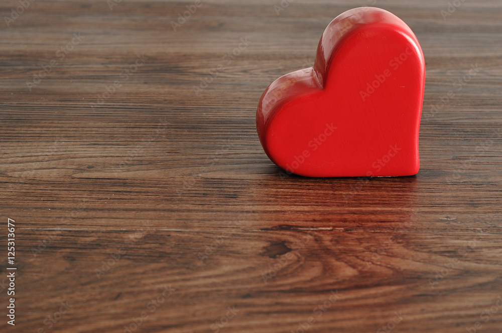 Valentines day. A red heart isolated on a wooden background Valentines day. A red heart isolated on a wooden background