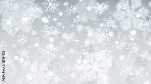 Christmas background of fuzzy and focused snowflakes