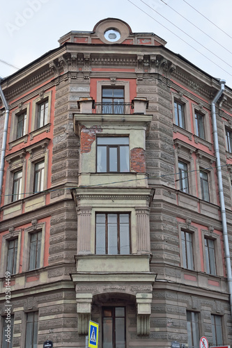 Old balcony with stucco mouldings and bars on the building
