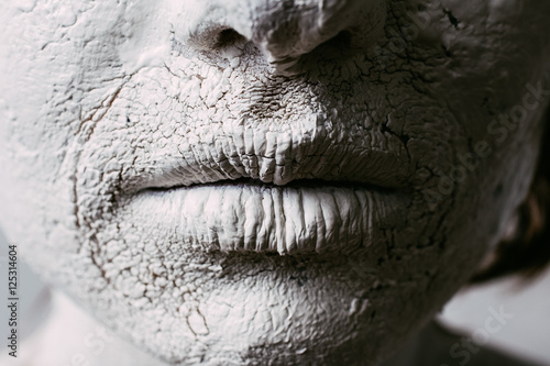 Woman face with cracked skin