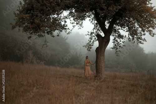 girl at lonely tree photo