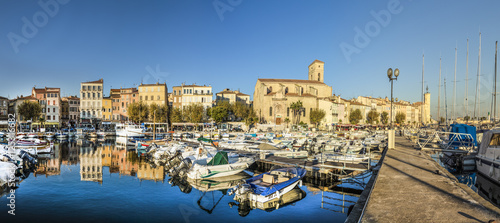 Yachts reflecting in blue water in the old town port of La Ciotat