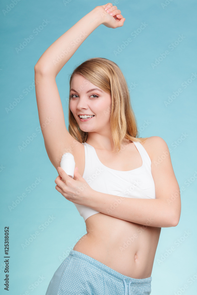 Girl applying stick deodorant in armpit. Girl applying stick deodorant in armpit.
